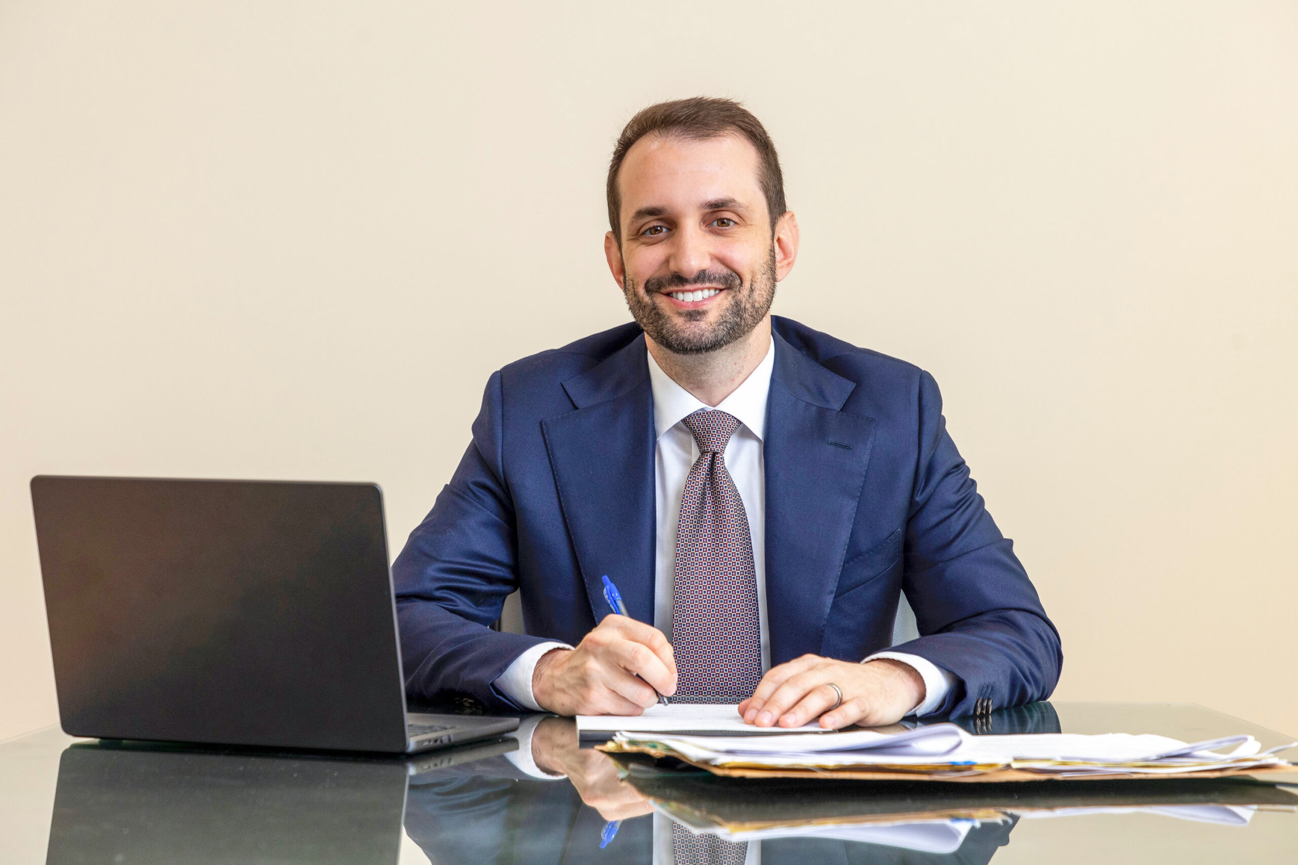 Adam Rose, experienced attorney, seated at desk with laptop and legal documents, representing Rose Injury Law.